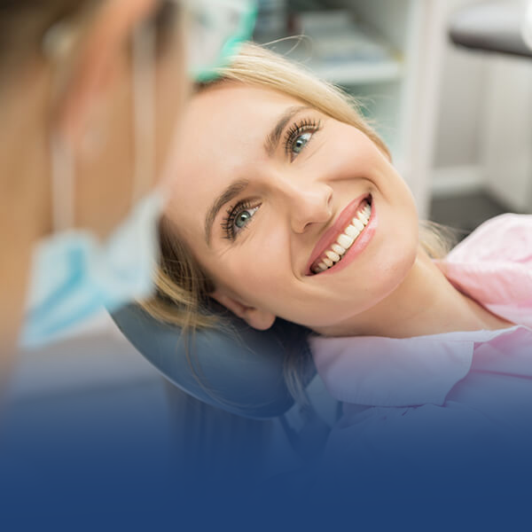 woman smiling to a dentist