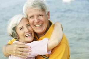 A mature couple embrace and smile